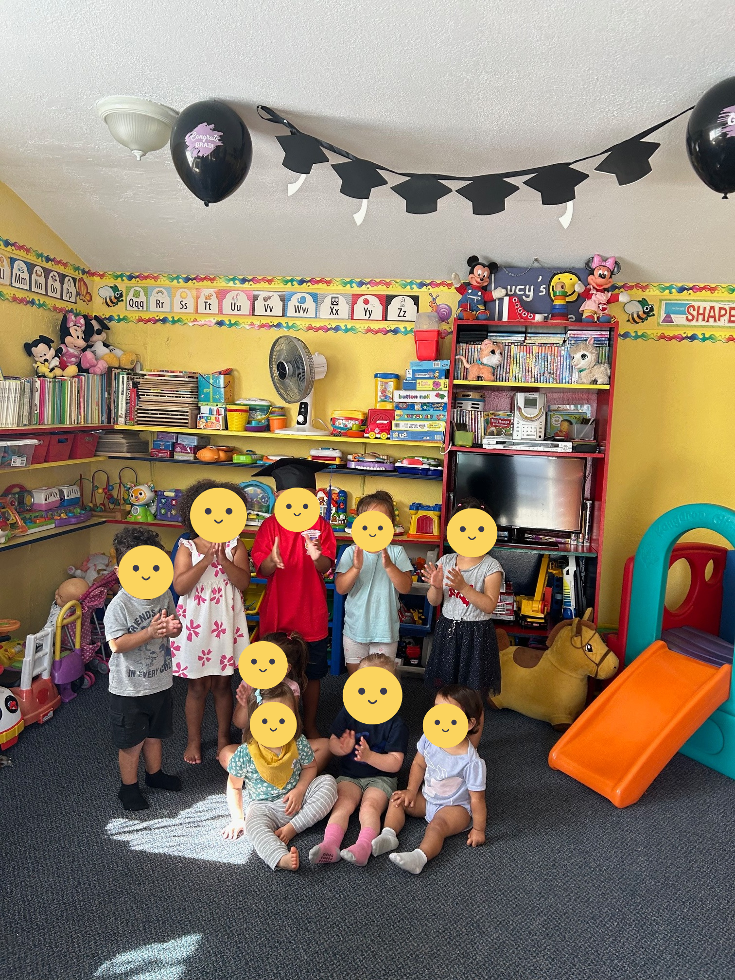 Children pose around a daycare graduate!